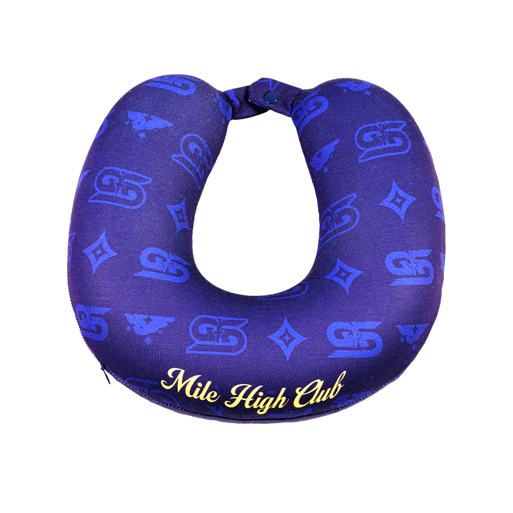 Close-up of a dark blue neck pillow with yellow "Mile High Club" text and subtle patterned design.