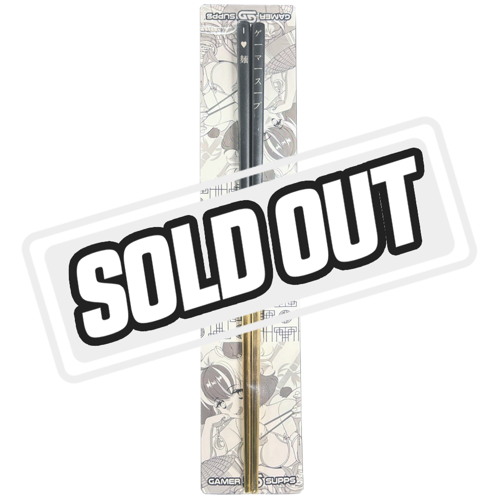 Black and gold chopsticks with white Japanese characters and a small heart on the black top section.
