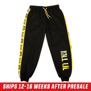 Black sweatpants with bold yellow "KILL LIL" text featuring an anime character graphic inside the letters.