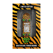 Miniature skateboard with black grip tape and bright green wheels on a natural wood deck edge.